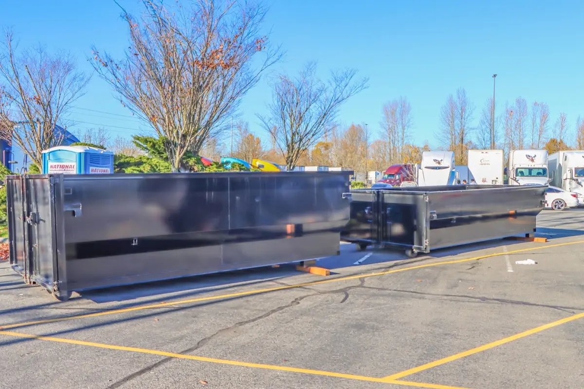 Professional dumpster rental service with roll-off container on residential driveway in Brewer